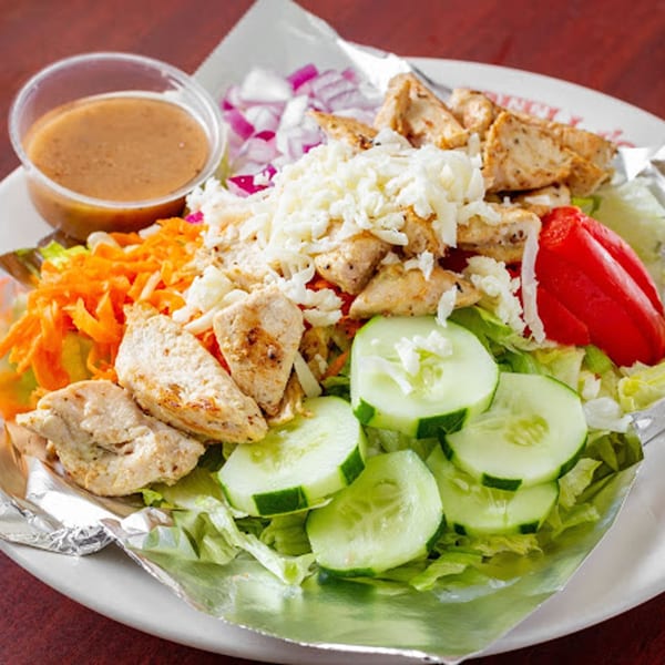 A G's Pizzeria chicken salad with lettuce, cucumbers, red peppers, onions, and dressing.